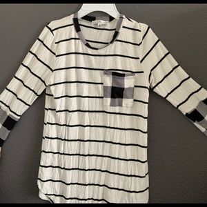 Cute white shirt with black stripes. Checkered at the wrists, pocket, and neck.